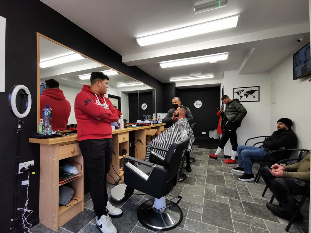 Picture of Rio De Janeiro barber shop with guilherme standing 