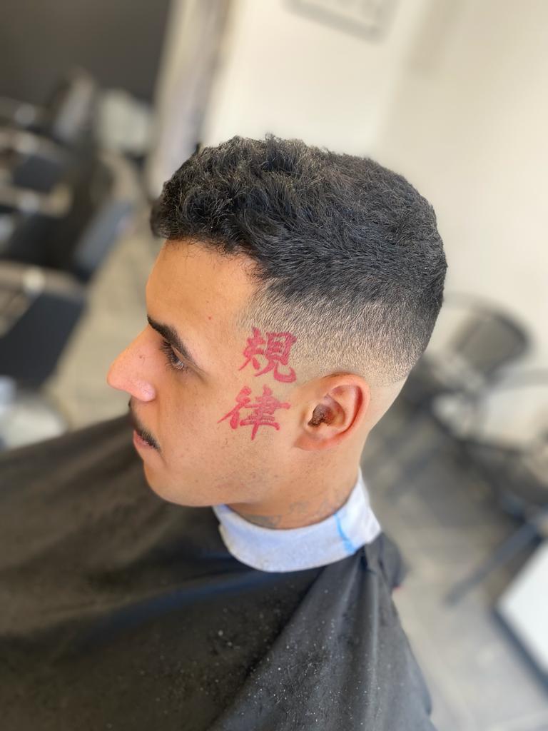 Man with tattoo looking fresh with his new hair cut